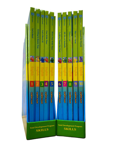 Set of educational books titled 'Total Development Program Skills' on a wooden surface with a light blue wall background.